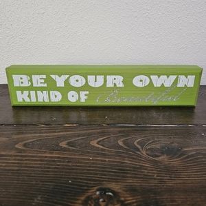 Green wooden block sign "Be Your Own Kind of Beautiful"